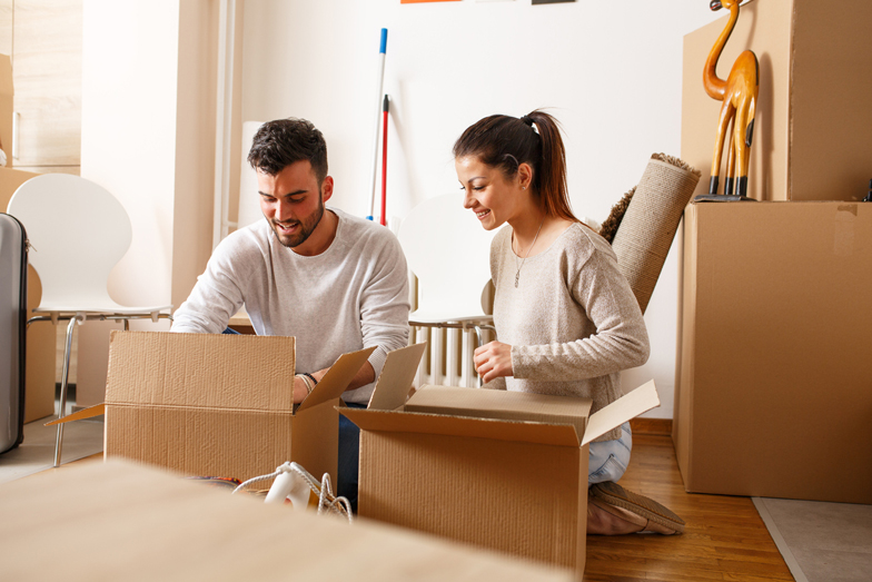 Household belongings being packed into a carton box